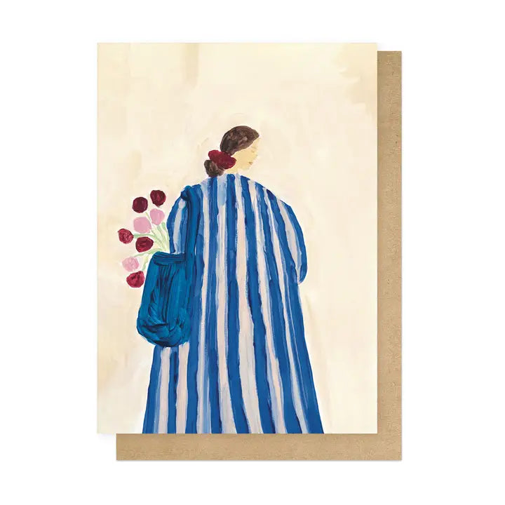 Greeting card with a painting of a person in a blue and white striped dress holding flowers, on a beige background.