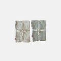 Two folded striped linen napkins with a ruffled edge with text on a white background