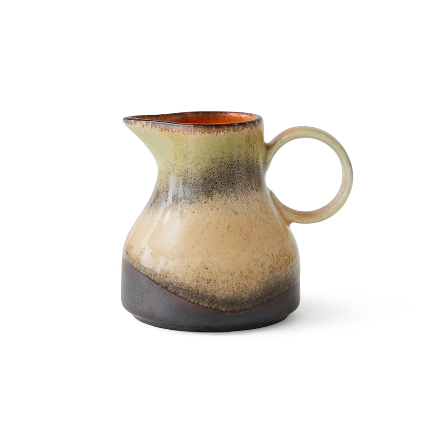Ceramic milk jug with a speckled design on a white background