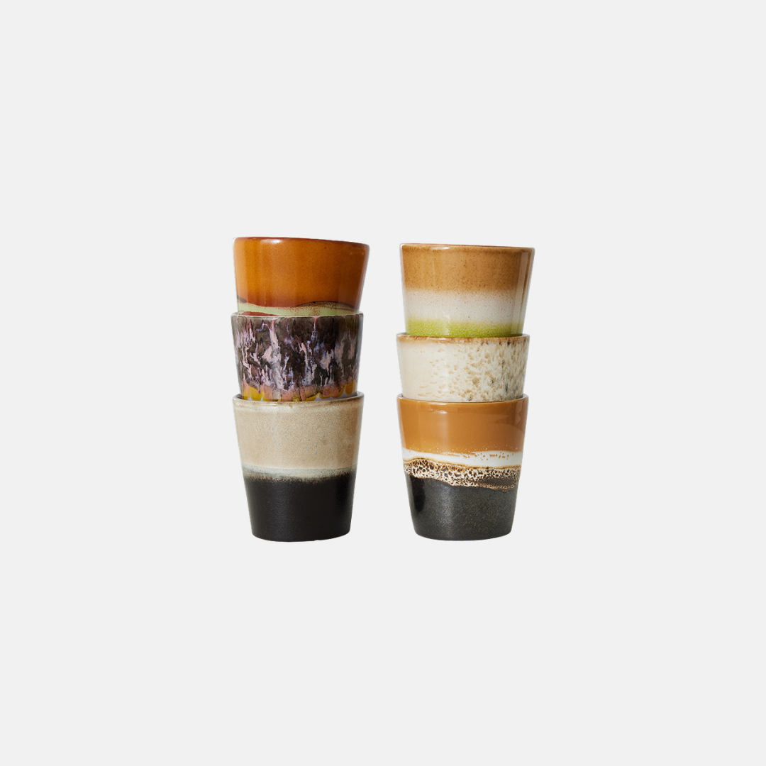 Two pairs of stacked ceramic cups with multi-colored, textured bands in orange, brown, cream, and black, set against a plain light gray background.