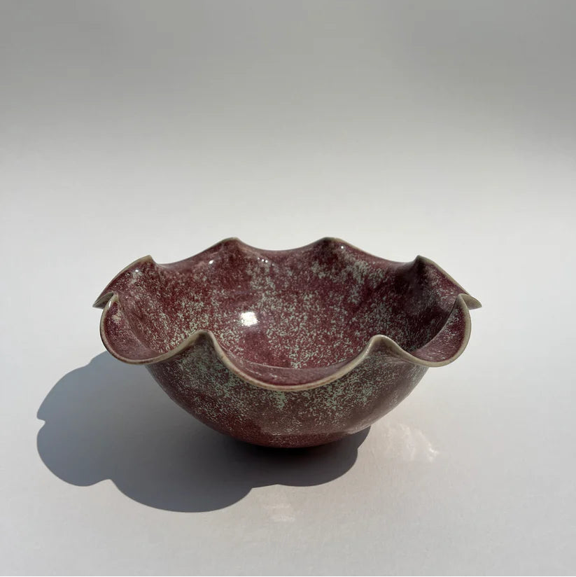 Ceramic bowl with a textured surface on a plain background