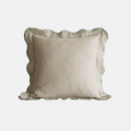 A square decorative throw pillow with a beige and white vertical stripe pattern, featuring a scalloped ruffled edge and a thin green border trim, shown against a plain light gray background.