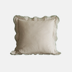 A square decorative throw pillow with a beige and white vertical stripe pattern, featuring a scalloped ruffled edge and a thin green border trim, shown against a plain light gray background.