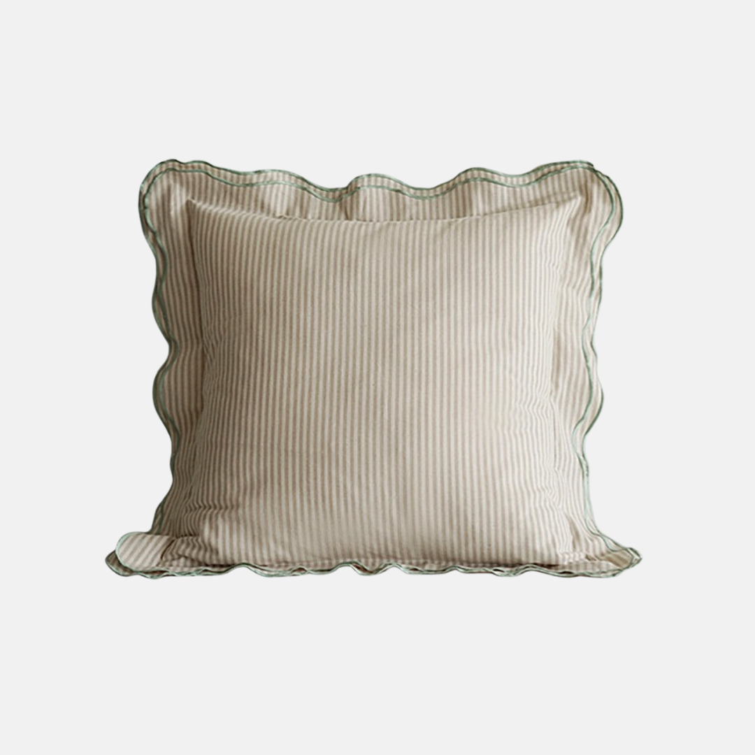 A square decorative throw pillow with a beige and white vertical stripe pattern, featuring a scalloped ruffled edge and a thin green border trim, shown against a plain light gray background.
