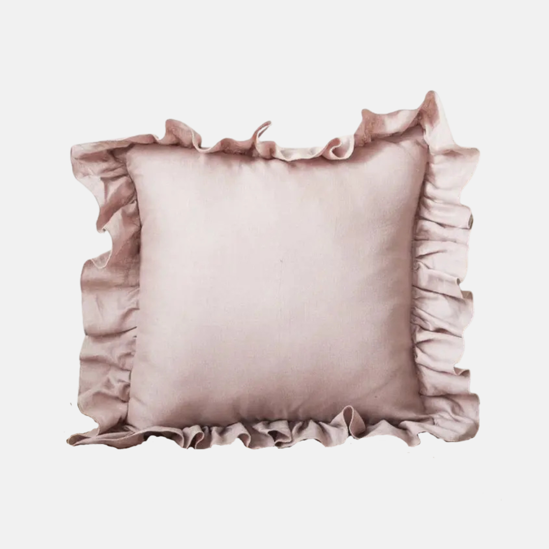 A square decorative throw pillow in a dusty rose pink color, featuring ruffled trim along all four edges, shown against a plain light gray background.
