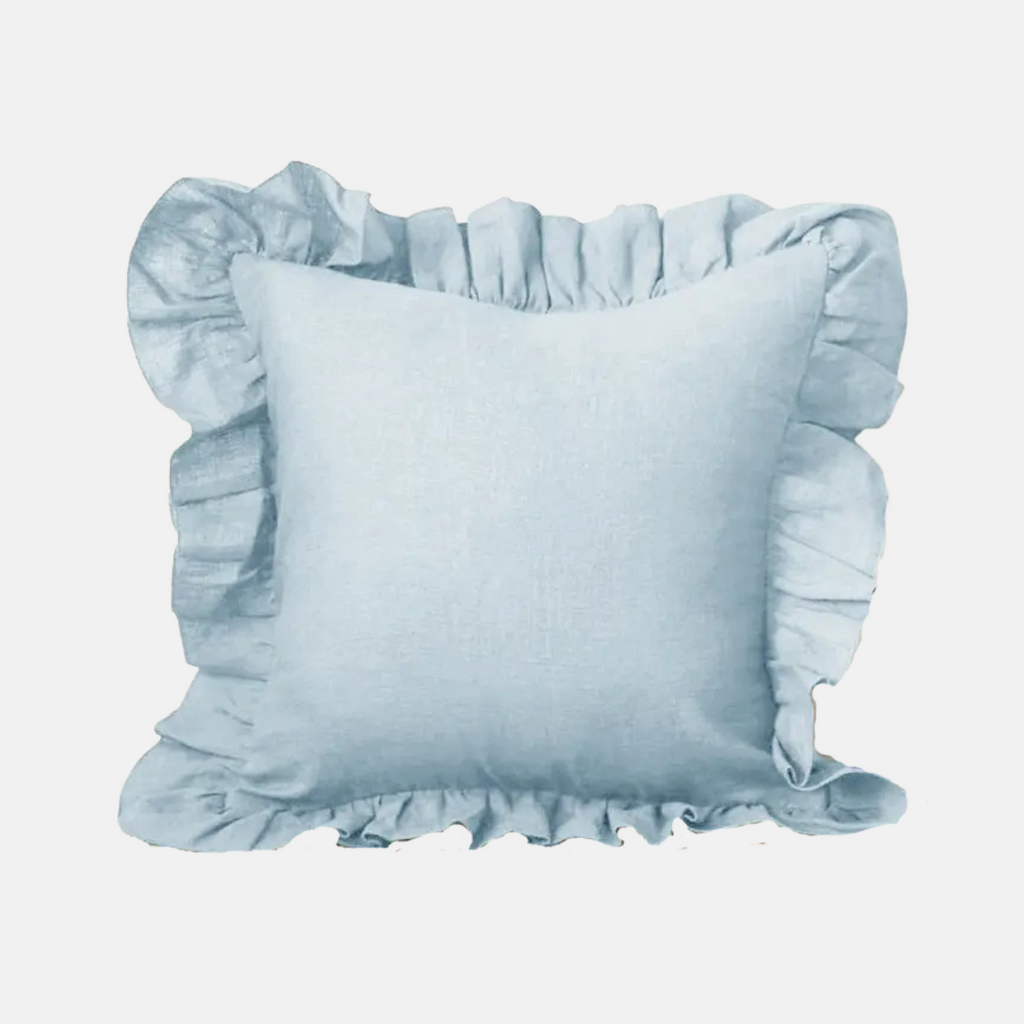 A square light blue pillow with ruffled trim around the edges, shown against a plain light gray background.