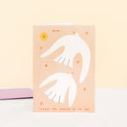 Greeting card with a white cat illustration on a peach background, featuring the word 'Mum' and text.