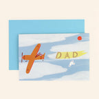 Greeting card with an airplane and 'DAD' banner on a blue background