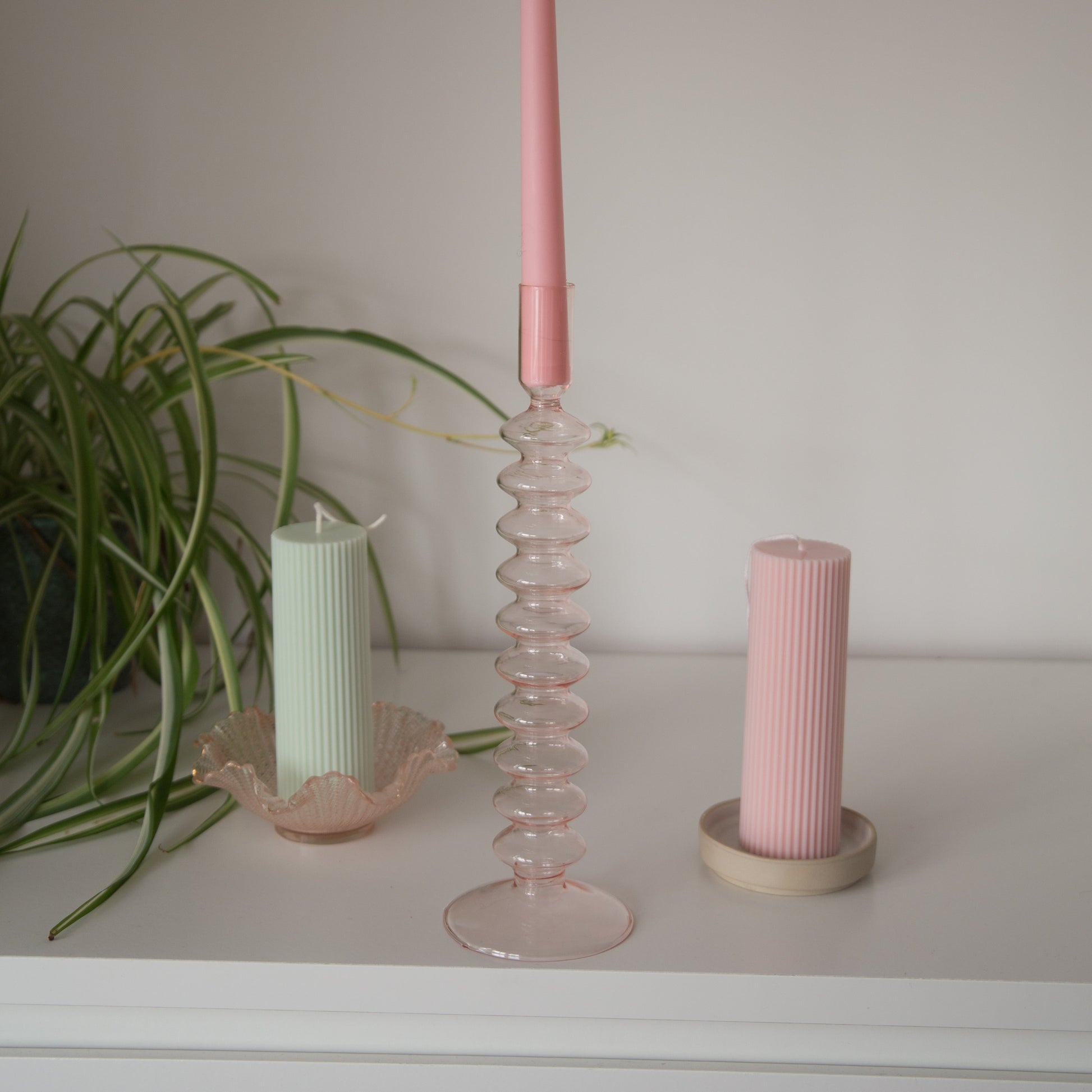 tall pink bubble candle holder with candles inside 