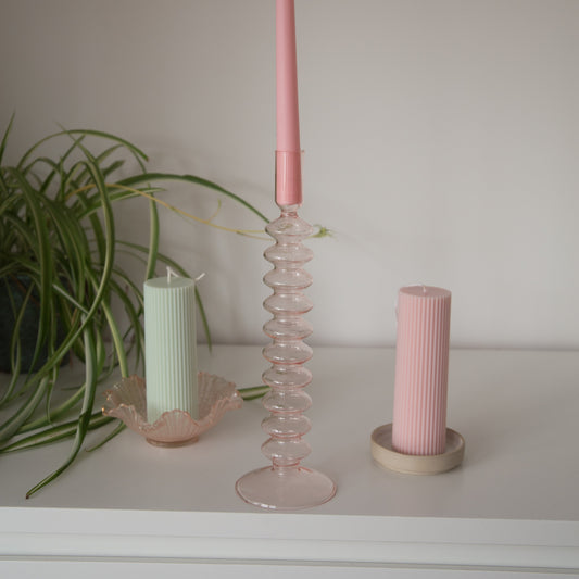 tall pink bubble candle holder with candles inside 