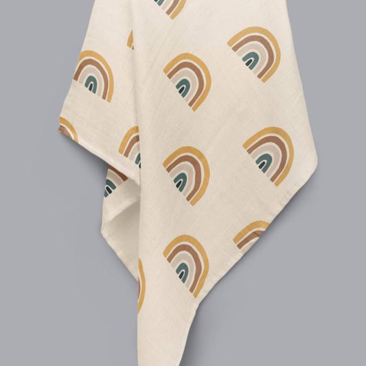 organic cotton baby muslin with rainbow pattern and a cream overall colour displayed hanging 