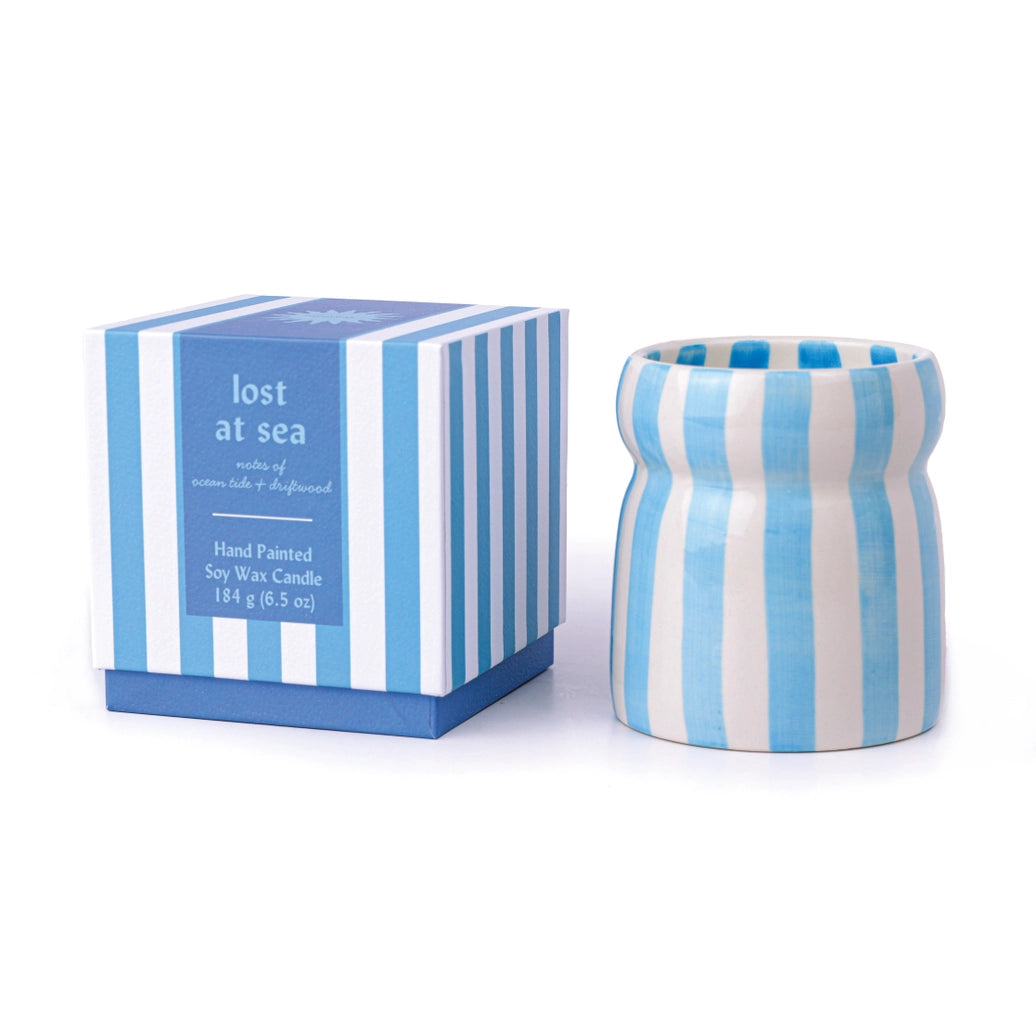 Blue and white striped candle with matching box on a white background