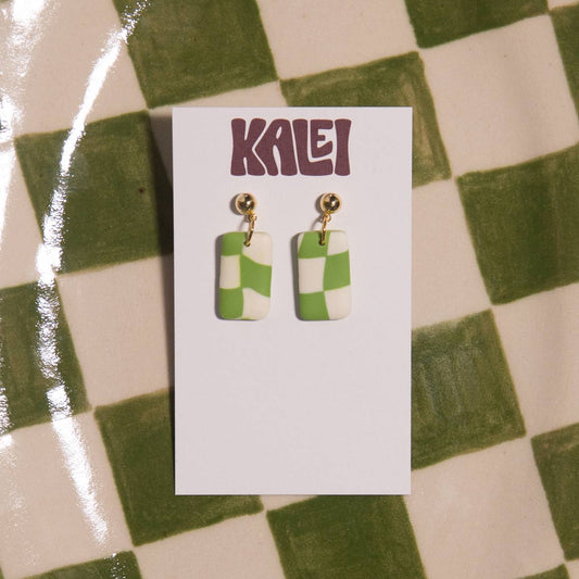 Green and white checkered earrings on a 'Kalei' branded card against a green and white checkered background.
