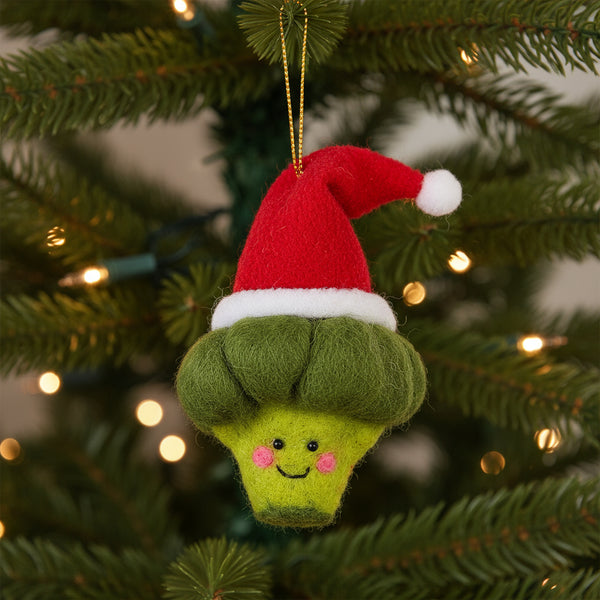 Felted broccoli ornament with a Santa hat on a white background