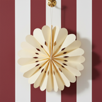 A white snowflake-shaped paper hanging decoration for Christmas.