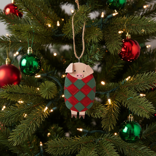 Decorative pig ornament with green and red pattern on a white background